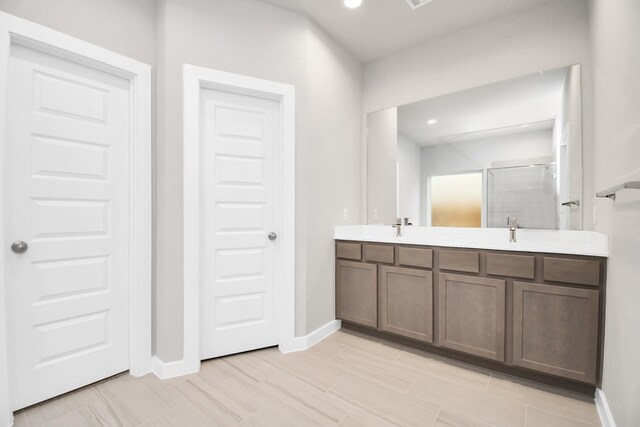 bathroom with an enclosed shower and vanity