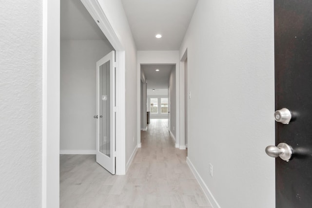 8447 Northern Pintail Dr, Houston, TX 77049 - hall with light wood-style floors, baseboards, and recessed lighting