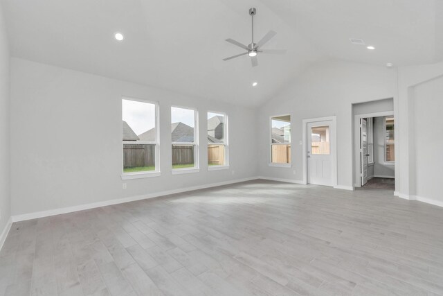 8447 Northern Pintail Dr, Houston, TX 77049 - unfurnished living room featuring vaulted ceiling, ceiling fan, light wood-style flooring, baseboards, and recessed lighting