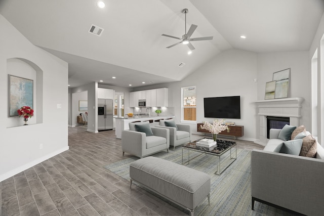 8447 Northern Pintail Dr, Houston, TX 77049 - living area featuring vaulted ceiling, baseboards, a ceiling fan, recessed lighting, and wood finished floors