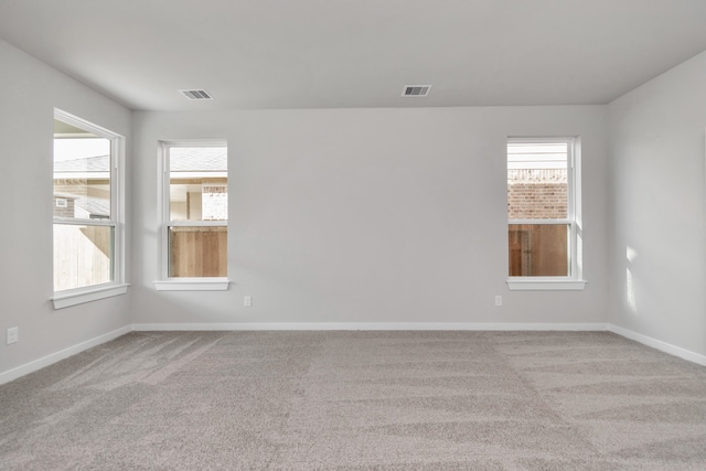 unfurnished room with light colored carpet