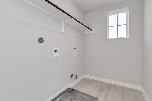 washroom with light hardwood / wood-style floors, hookup for a washing machine, gas dryer hookup, and electric dryer hookup