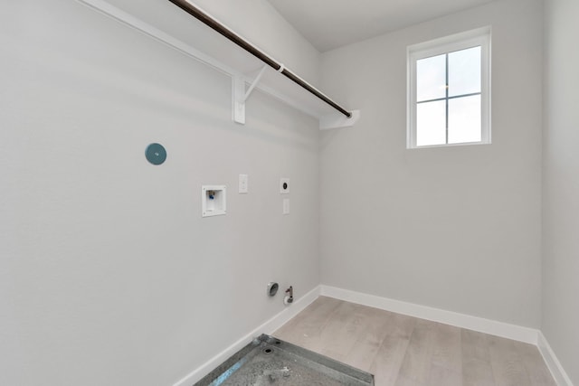 8447 Northern Pintail Dr, Houston, TX 77049 - washroom featuring hookup for a gas dryer, electric dryer hookup, washer hookup, baseboards, and light wood finished floors