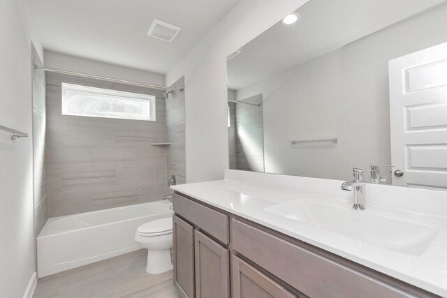 8447 Northern Pintail Dr, Houston, TX 77049 - bathroom featuring toilet, vanity, shower / bath combination, and wood finished floors