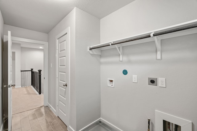 laundry area with hookup for a washing machine, light hardwood / wood-style flooring, hookup for a gas dryer, and electric dryer hookup