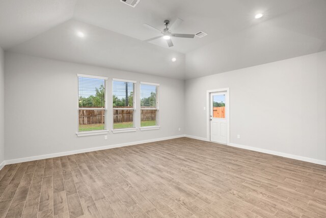 spare room featuring lofted ceiling, light hardwood / wood-style flooring, and ceiling fan