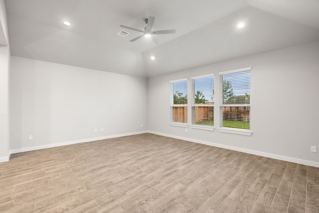 spare room featuring lofted ceiling, light hardwood / wood-style flooring, and ceiling fan