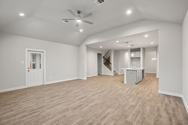 unfurnished living room featuring light wood-type flooring, ceiling fan, lofted ceiling, and sink