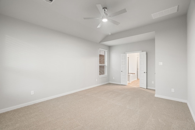 unfurnished room featuring vaulted ceiling, light colored carpet, and ceiling fan