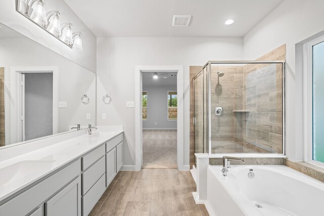 bathroom featuring hardwood / wood-style floors, separate shower and tub, and vanity