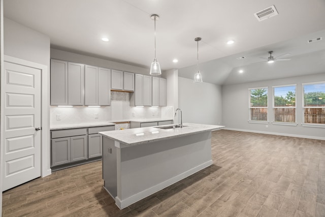 kitchen with gray cabinetry, wood-type flooring, sink, lofted ceiling, and ceiling fan