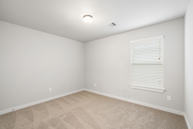 empty room featuring light colored carpet