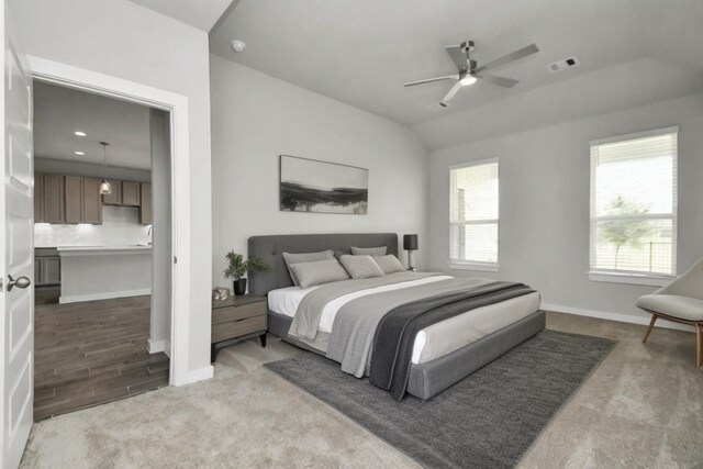 bedroom featuring lofted ceiling, ceiling fan, and carpet