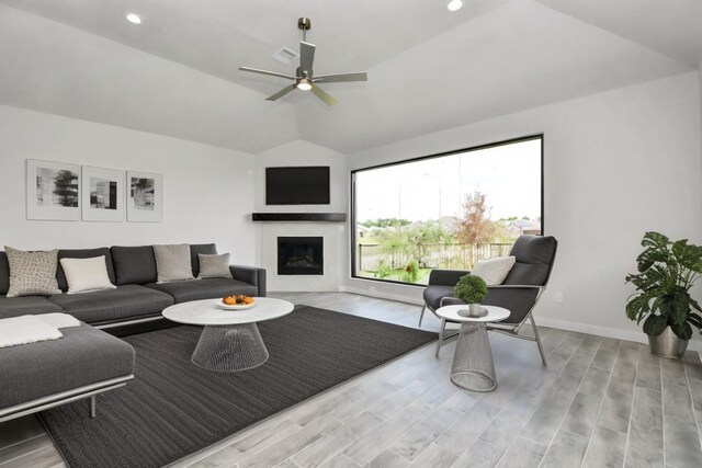 living room featuring light wood-type flooring, lofted ceiling, and ceiling fan