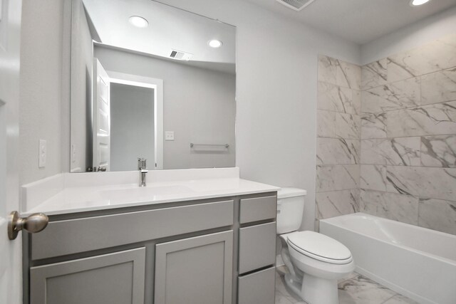 full bathroom with vanity, toilet, and tiled shower / bath