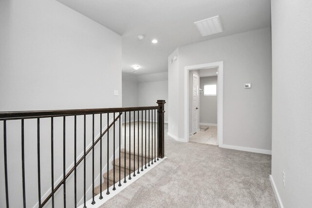 hallway with light carpet