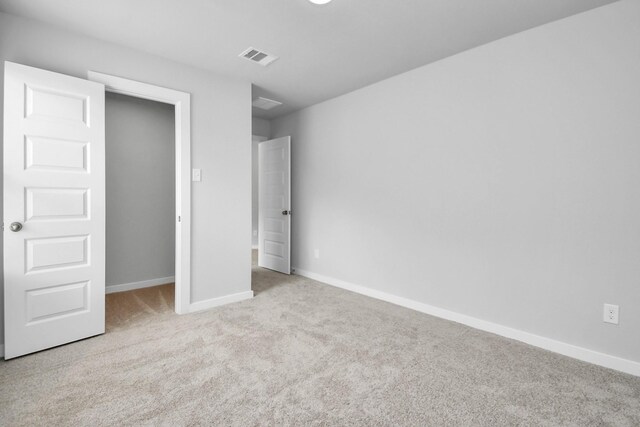 unfurnished bedroom with light colored carpet