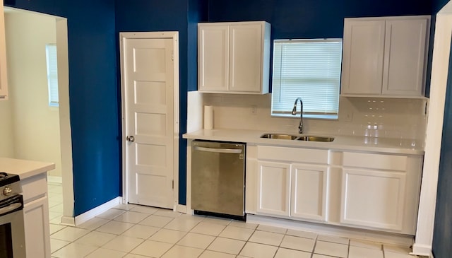 kitchen with light tile patterned floors, dishwasher, white cabinetry, and sink