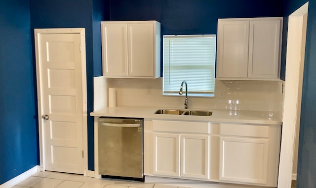 kitchen with dishwasher, light tile patterned floors, sink, and white cabinets