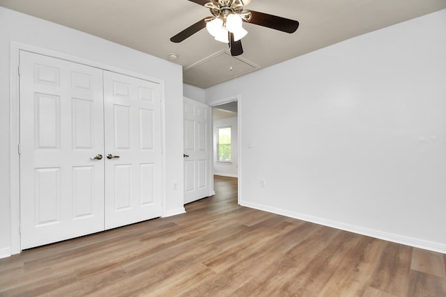 unfurnished bedroom featuring a closet, ceiling fan, and wood-type flooring