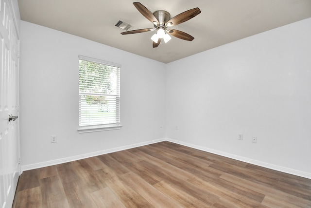 unfurnished room with hardwood / wood-style floors and ceiling fan