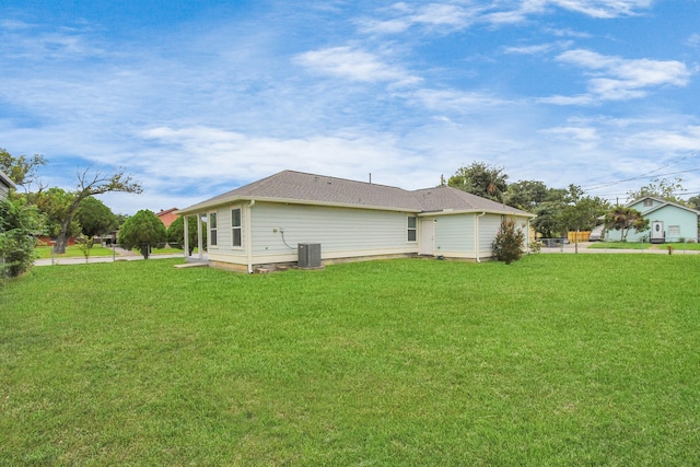 view of home's exterior featuring central air condition unit and a lawn