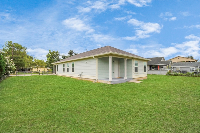 back of property featuring a lawn and a patio area