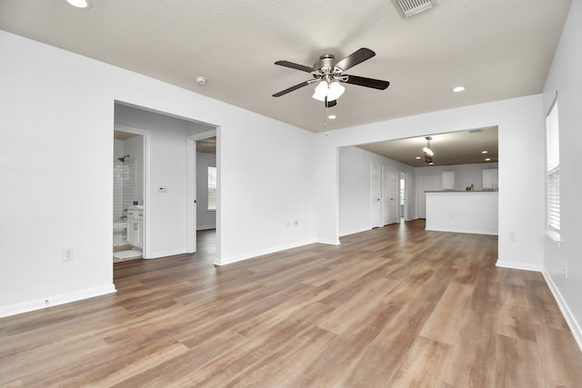 unfurnished living room featuring hardwood / wood-style floors and ceiling fan