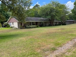 ranch-style home featuring a front yard