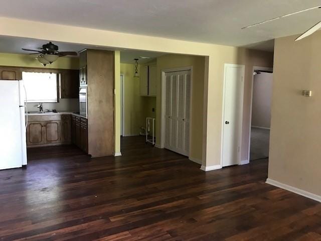 1702-1704 Southline St Unit 170, Cleveland, TX 77327 - kitchen with freestanding refrigerator, a ceiling fan, dark wood finished floors, and baseboards