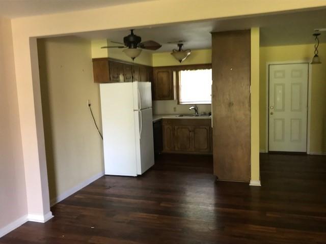1702-1704 Southline St Unit 170, Cleveland, TX 77327 - kitchen featuring freestanding refrigerator, ceiling fan, a sink, dark wood-type flooring, and baseboards