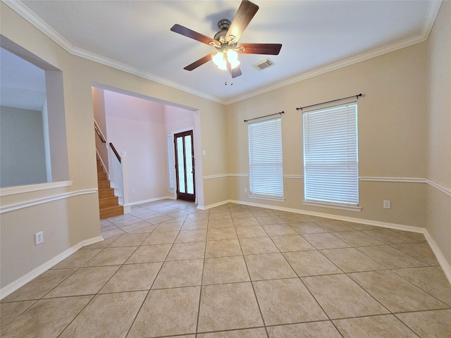 tiled empty room featuring ornamental molding and ceiling fan