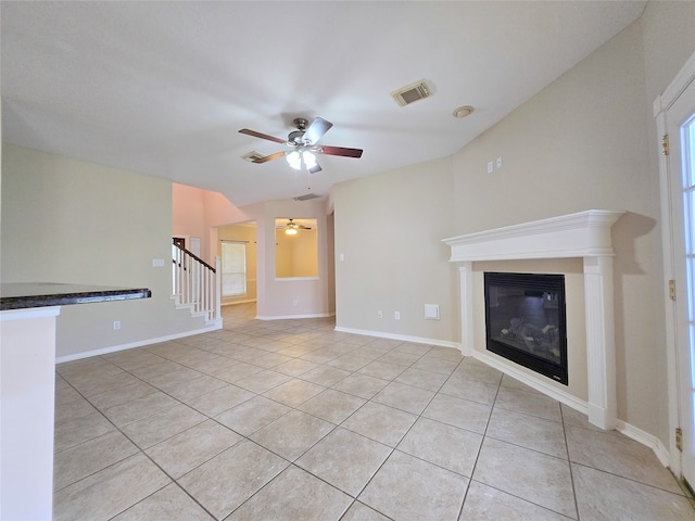 unfurnished living room featuring ceiling fan and light tile patterned floors