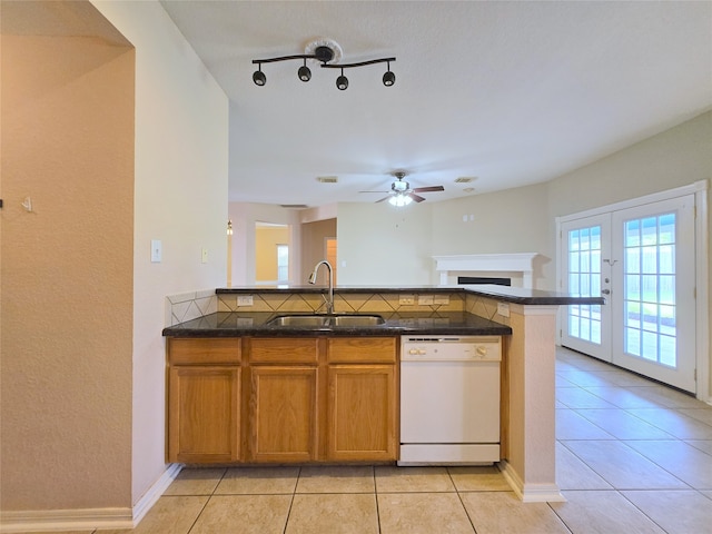 kitchen featuring light tile patterned flooring, sink, french doors, white dishwasher, and kitchen peninsula