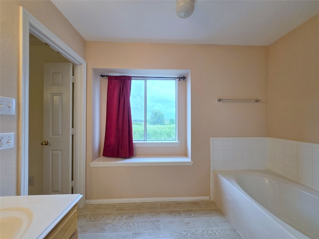 bathroom with vanity, a bathtub, and tile patterned floors