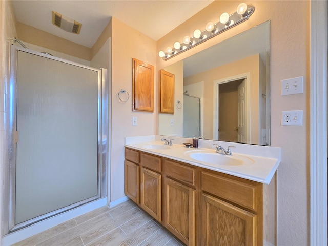 bathroom with vanity, wood-type flooring, and walk in shower