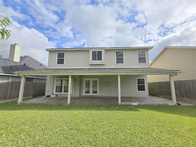 back of house featuring a yard, a patio area, and french doors