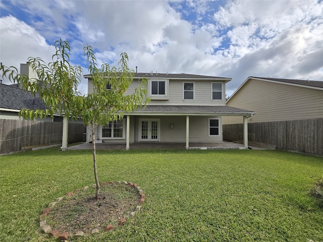 rear view of property featuring a patio and a lawn