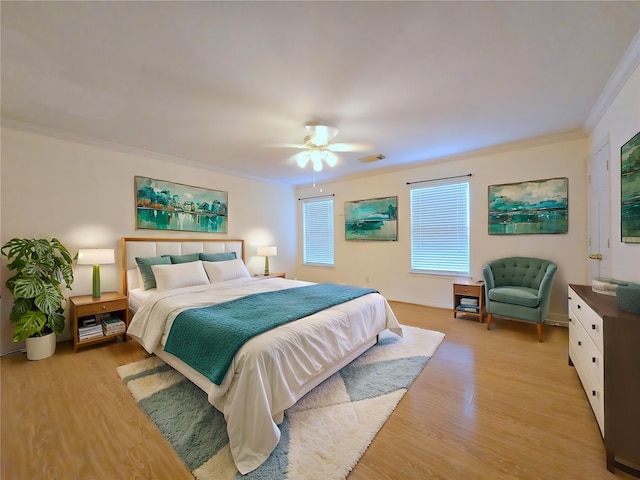 bedroom with ceiling fan, crown molding, and light hardwood / wood-style floors