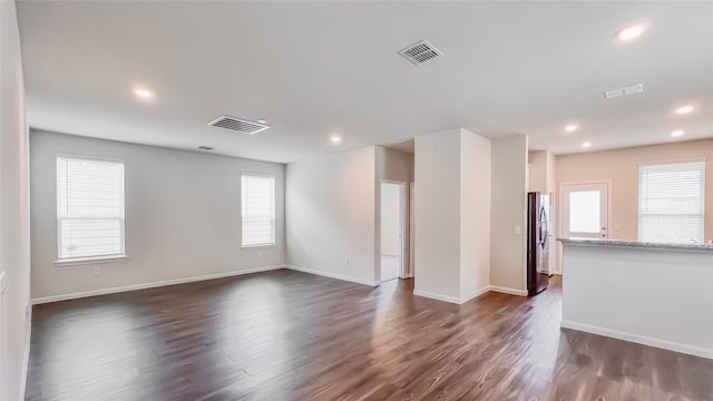 unfurnished living room with dark wood-type flooring