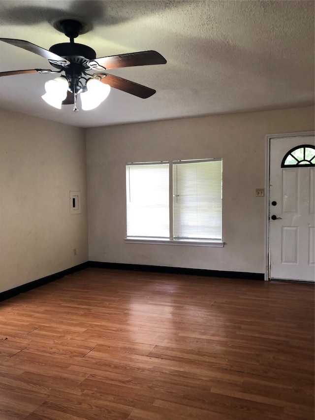 foyer entrance featuring ceiling fan, hardwood / wood-style floors, and a textured ceiling