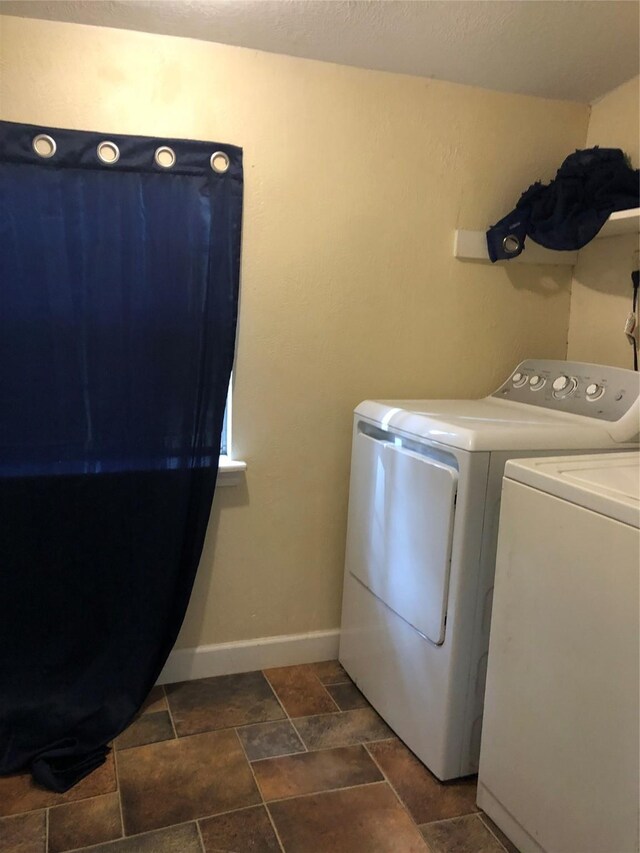 clothes washing area featuring washing machine and clothes dryer