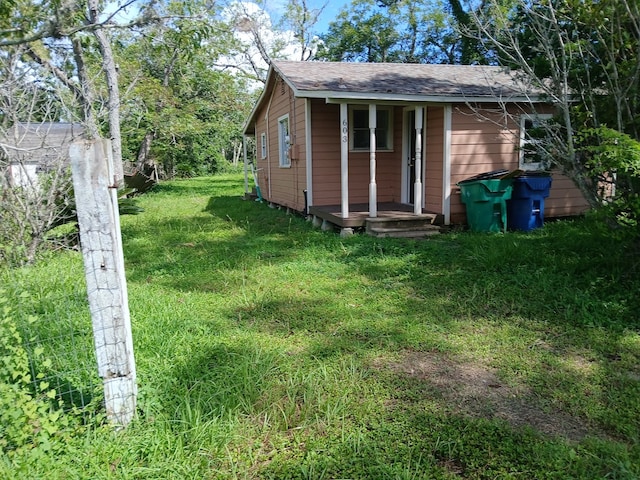 exterior space with an outbuilding and a front lawn