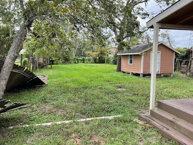 view of yard with a deck and a storage shed