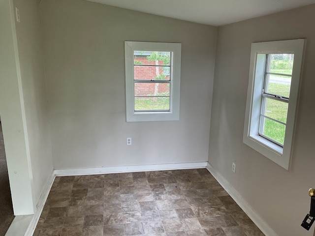 unfurnished room with vaulted ceiling and plenty of natural light