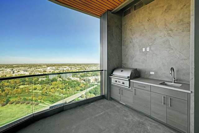 balcony with an outdoor kitchen, area for grilling, and sink