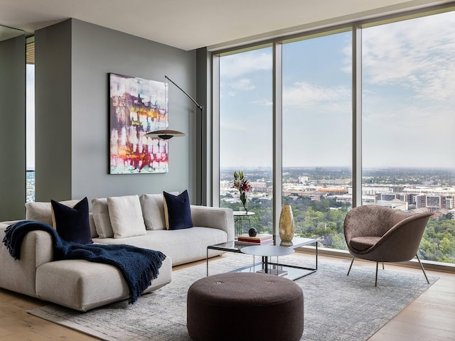 living room with light wood-type flooring and floor to ceiling windows