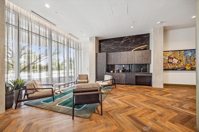 living room featuring parquet floors and a healthy amount of sunlight
