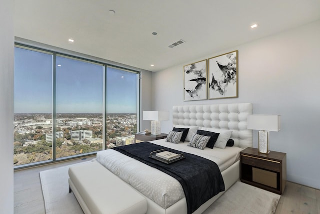 bedroom featuring expansive windows and multiple windows