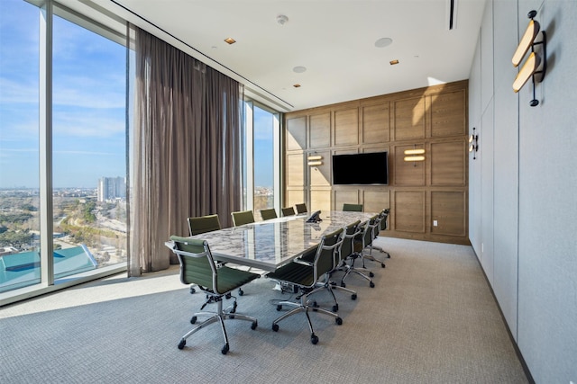 home office with expansive windows and light carpet